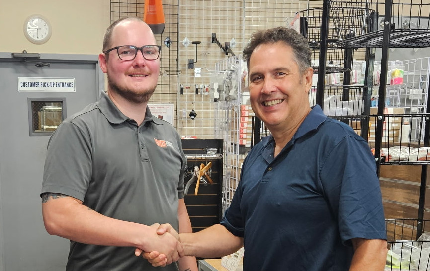 Drew Telesca, Chief Operating Officer, shaking hands with Tim Enright, CEO of Discount Shelving